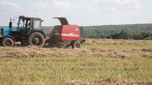 harvesting hay in a field on a summer day