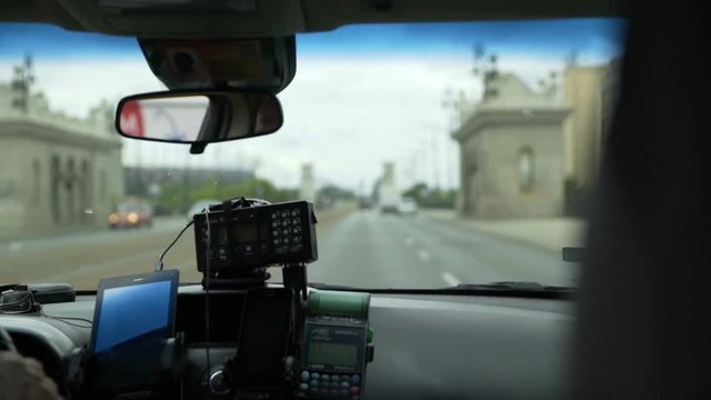 POLAND 2016: A few people are driving in a car on a highway in a large city and they are also using a GPS. Close-up shot.
