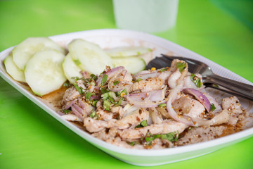 Thai food spicy pork salad, Nam Tok  Moo ,on green background
