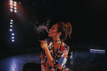 Woman with cigarette exhaling smoke