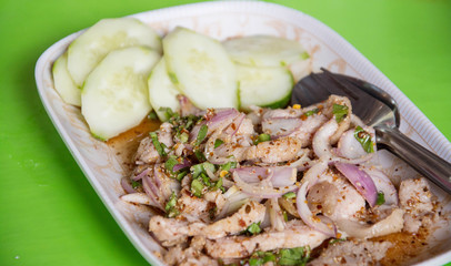 Thai food spicy pork salad, Nam Tok  Moo ,on green background
