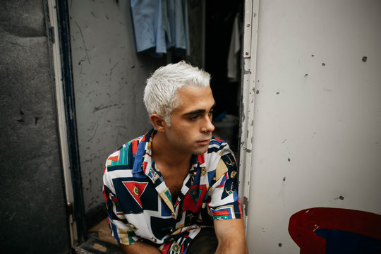 Man with bleached hair looking away
