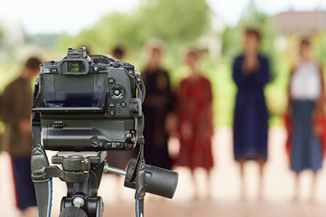  Camera on the tripod shooting the chorus of teens