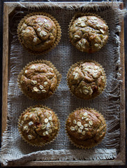 Healthy wholewheat and oatmeal muffins, served in a box, closeup, overhead view