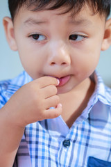 Little boy eating candy.