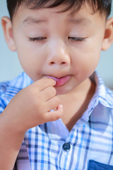 Little boy eating candy.