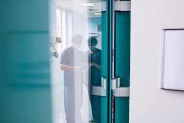 Surgeons discussing over digital tablet