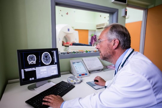 Doctor examining brain mri scan on computer