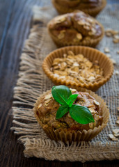 Healthy zucchini and oatmeal muffins on a rustic background