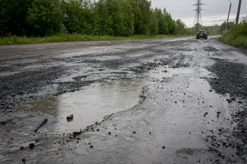 Potholes and puddles on the road