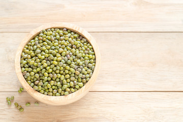 raw mung beans in the wooden bowl.
