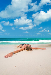 Fototapeta na wymiar Cute woman relaxing on the beach