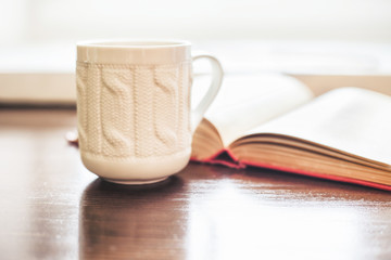 Coffee cup and open book
