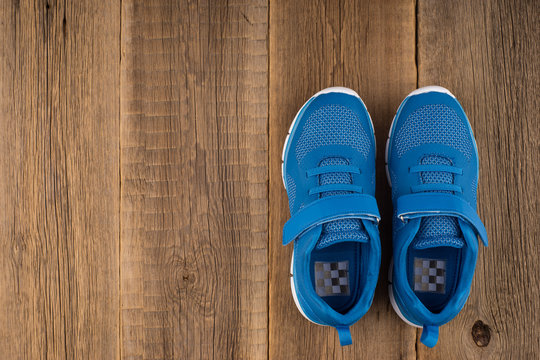 Blue Sneakers with wooden background