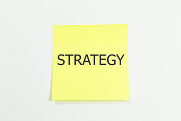 Strategy word written on yellow sticky notes. isolated on white