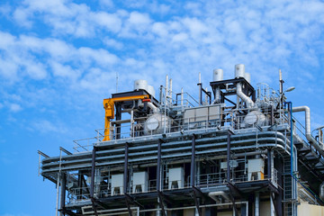 Top floor of boiler or HRSG of combine cycle power plant against blue sky