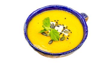 Pumpkin and carrot cream soup isolated on white