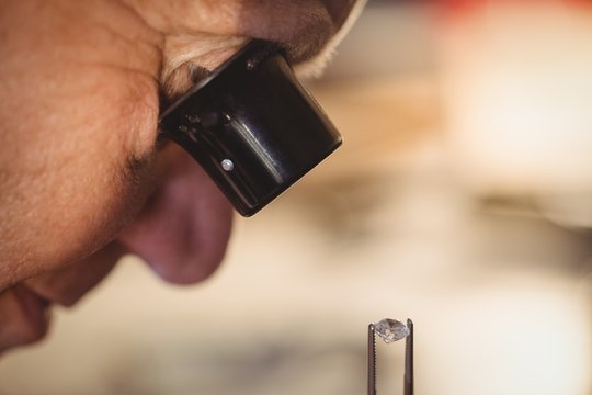 Goldsmith examining diamond