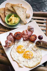traditional english british fried breakfast with eggs bacon and