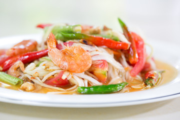 Green papaya salad with dried salted prawn in white dish  (Thai