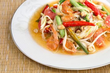 Green papaya salad with dried salted prawn in white dish on brow