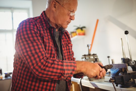 Goldsmith working in workshop
