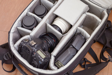 The Camera with Lenses and Flash in a Backpack