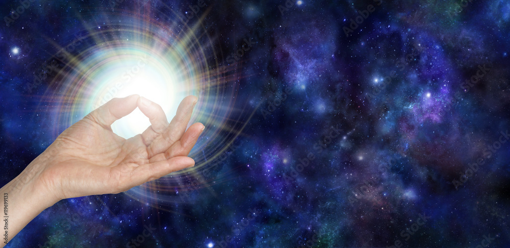 Wall mural gyan mudra and the spark of life - female hand with thumb and index finger touching giving out a bri