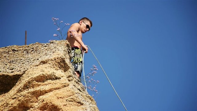 Climber Throwing The Rope And Knot Tying