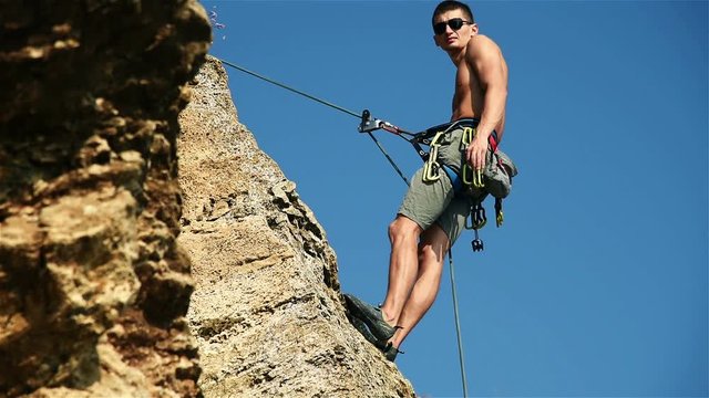 Climber Hanging On The Rock And Shows Thumb Up. Slow Motion Effect