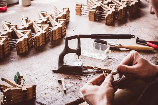 Piano technician working on piano parts