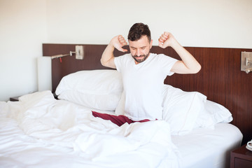 Man stretching and yawning in bed