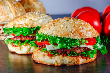 Close-up of home made tasty burgers on wooden table