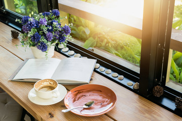 Empty coffee cup and empty plate after drink coffee and cake wit