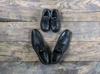 Men's and women's shoes on the old wooden floor