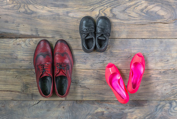 Men's and women's shoes on the old wooden floor