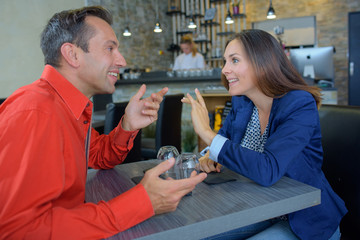 Couple in bar talking excitedly