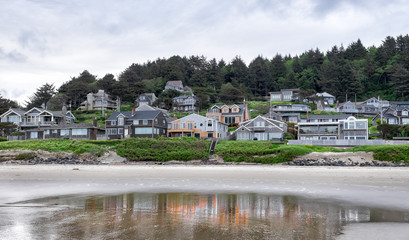 Fototapeta na wymiar Oregon coast houses viewed from the water. Typical style 