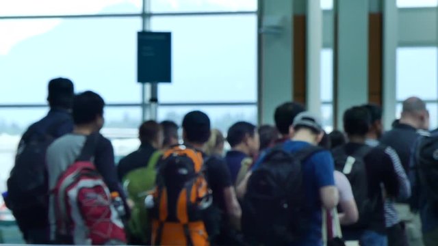 OUt of focus group of passengers boarding plane
