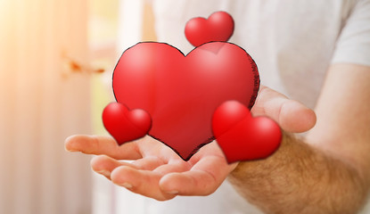 Young man holding hand drawn red heart