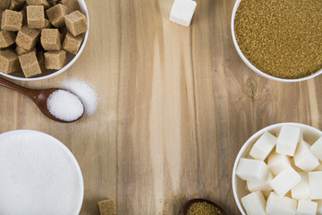Cane and white sugar in a white bowls