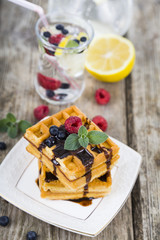 Delicious waffles and homemade lemonade with berries