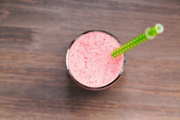 Watermelon smoothie in a glass on wooden table