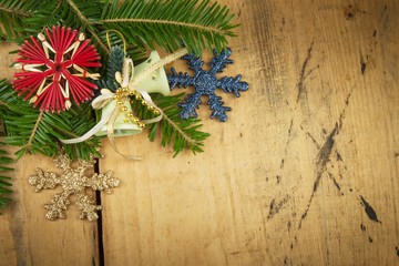 Christmas decoration on a wooden board. Christmas background. Christmas fir tree with decoration on a wooden board. Christmas background with balls and decorations over wooden table