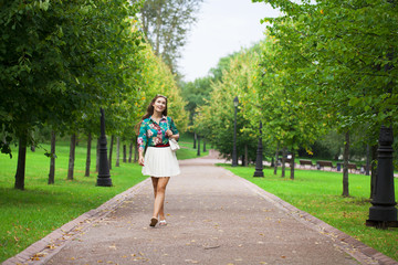 Fototapeta premium Young brunette woman in white skirt