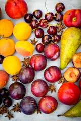 Stone Autumn fruit on the wooden table, flat view.