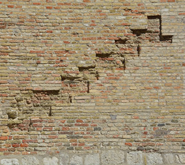 A brick wall in an old historic building in the north east Italian town of Pordenone in Friuli Venezia Giulia
