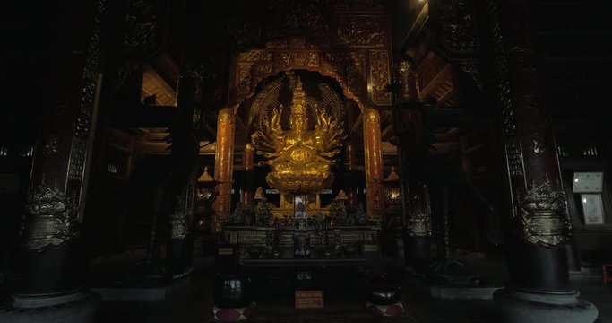 Temple interior and bronze statue of Quan Am Buddhist statue with altar. Visiting Bai Dinh Temple Spiritual and Cultural Complex in Vietnam