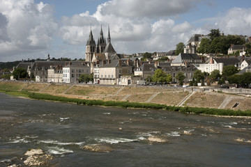 Fototapeta na wymiar Blois France - The Chateau Royal and the Church of Saint Nicholas overlook the River Loire at Blois France