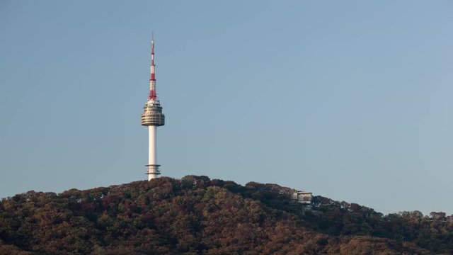 Time lapse shot of freestanding tower in the forest against blue sky clear background. Seoul, South Korea